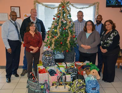 CDEC employees around a Christmas tree